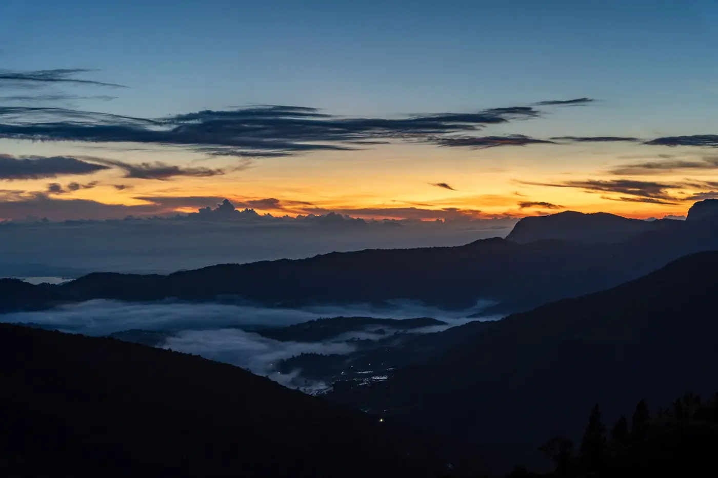 A breathtaking sunrise over misty mountains, creating a serene and tranquil atmosphere.